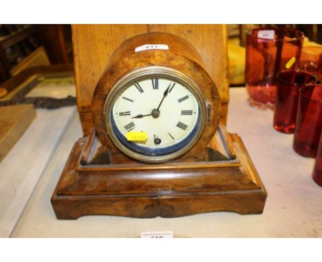 A Victorian walnut single hole mantel clock