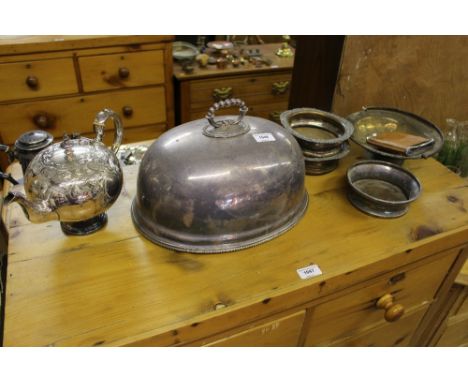 A silver plated meat dish cover; a plated teapot with foliate engraved decoration; a pair of coasters; a single similar etc. 