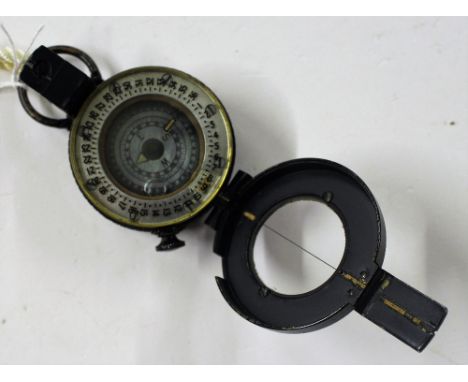 A military compass in leather carrying case 