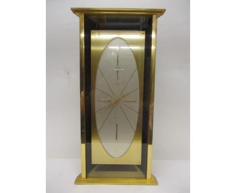 A 1970s Luxor precision mantle clock retailed by Asprey, in a brass and rosewood effect case, battery operated movement, sign