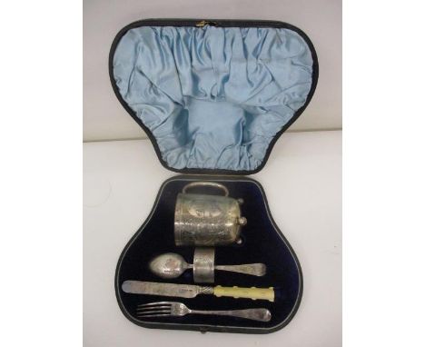 A Victorian silver five piece christening set by Walker & Hall, Sheffield 1885/1886, comprising a mug with a domed bottom on 