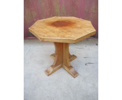 A Robert Thompson Mouseman  oak occasional table with an octagonal carved honeycomb top, over a crossover column, raised on c