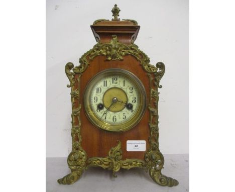 A late 19th/early 20th century ormolu mounted, continental mantle clock in a walnut case, the movement striking on a gong, 15
