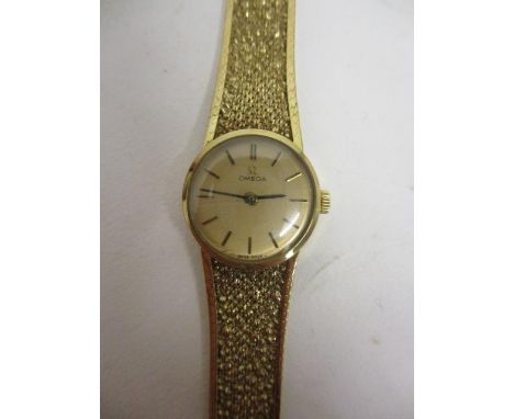 An Omega ladies manual wind, 9ct gold cased wristwatch, having gilt dial, baton markers with original Omega 9ct gold bracelet