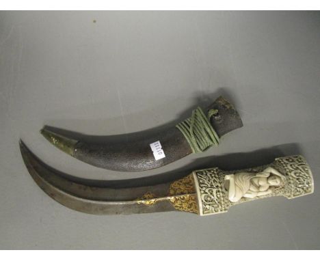 A fine early 19th century Persian Qajar (Jambya) dagger, probably Iranian, with waisted walrus ivory handle, ornately carved 