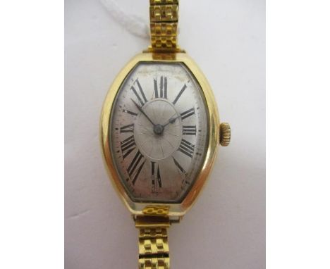 An Art Deco manual wind, 18ct gold wristwatch having silvered dial with Roman numerals and spade hands.  The 15 jewel movemen