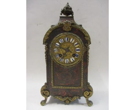 A late 19th century boulle work mantle clock having gilt metal decoration, arched case, basket of flowers finial, standing on