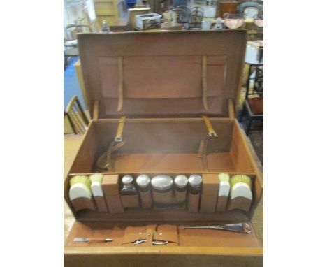 A 1930s brown leather gentleman's fitted suitcase with locks, a buckled, fold over panel to the lid and a fall front enclosin