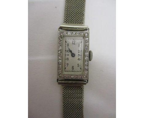 An early 20th century ladies manual wind, platinum cocktail watch circa 1920, the platinum case inset with diamond chips on a