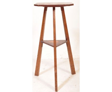 A vintage 20th Century inlaid mahogany tripod table having a canted square top inlaid with leaves and a camouflage turtle. Se