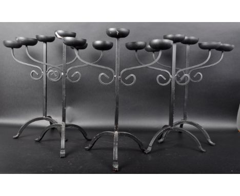 A matching set of five Contemporary wrought iron candlestick holders / candelabras with each having two scrolled arms holders
