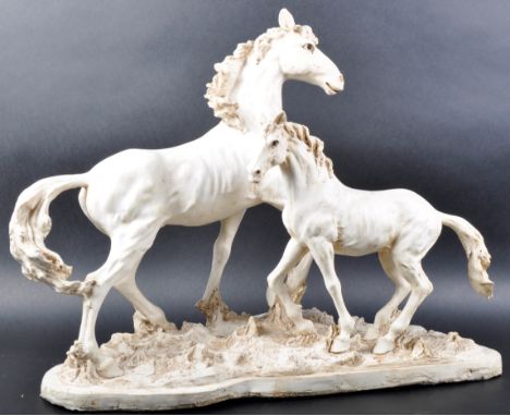 A large 20th Century Italian ceramic figure group depicting a horse and&nbsp;foal stood upon a naturalistic base. Unmarked. M