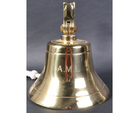 A 20th Century solid brass nautical / maritime ships bell of typical form with adjustable mounting bracket. Inscribed A.M.L. 