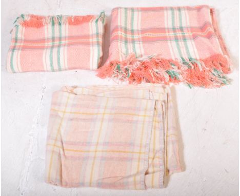 Three large vintage 20th Century woolen Welsh blankets with two matching having a pink and green background overlapping to fo