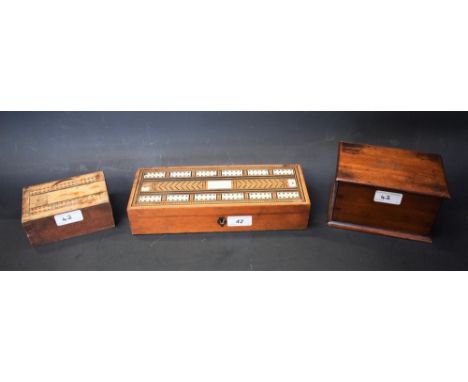 A 19th century mahogany and marquetry rectangular playing card box, the hinged cover inlaid for cribbage, enclosing compartme