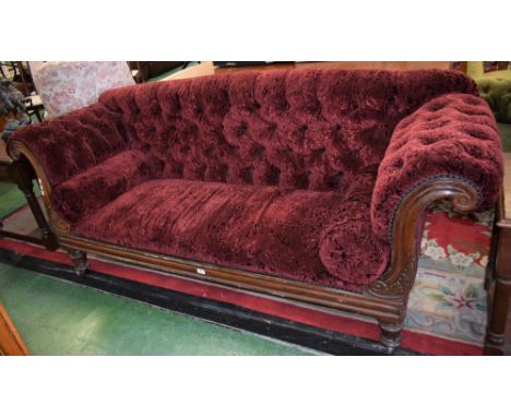 A William IV rosewood scroll end sofa, deep buttoned stuffed over upholstery, the substantial frame carved with acanthus, tur