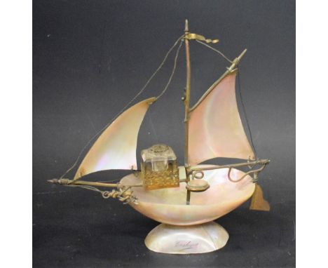 A 19th century souvenir mother of pearl novelty inkstand, as a sailing boat, mounted with a glass well and a compass, the bas