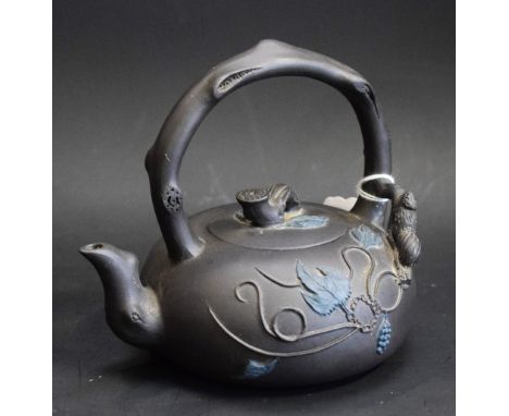 A Chinese Yixing Duan Ni tea kettle, of small proportions, moulded in high relief with scrolling leafy stems, arched branch h