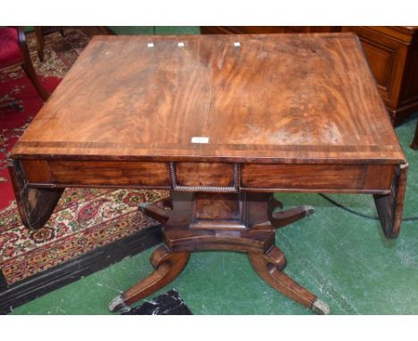 A Regency mahogany crossbanded dropleaf sofa table, rounded rectangular top above a pair of frieze drawers, square pillar, br