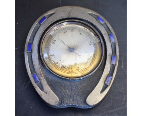 An early 20th century silvered copper and enamel novelty desk barometer, as a horseshoe, 5cm circular register, 8.5cm long, c