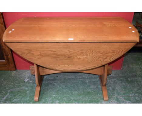 An Ercol style dropleaf table, trestle base, 121cm wide