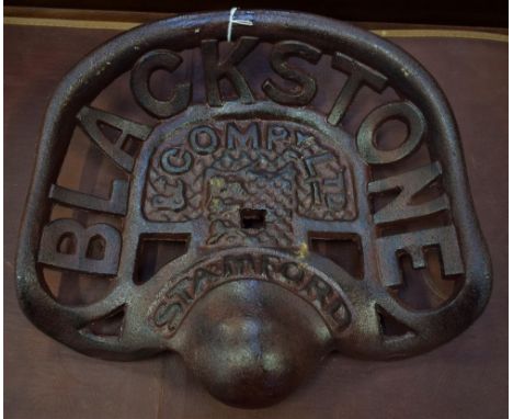 A reproduction cast metal Blackstone tractor seat