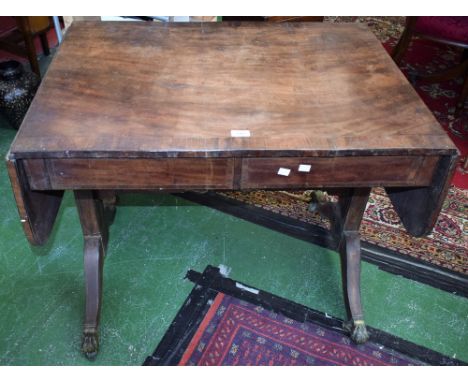 A George III mahogany crossbanded drop leaf sofa table, brass lion paw feet, 151cm wide, c.1810