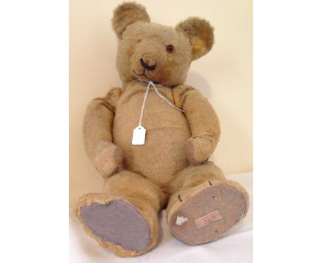 A large vintage jointed golden Chad Valley teddy bear c.1930's/40's Label still on underside of left foot.  One eye missing a