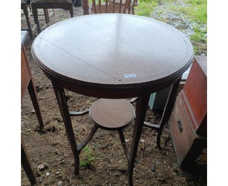 A mahogany lamp table, 68 cm diameter, a painted trunk, 48 cm wide, two other trunks and three suitcases (qty)  Please note c