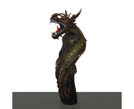 Wooden sculpture of a Chinese dragon climbing a trunk. Open jaws, red tongue and glassy red eyes. Sculpted and painted surfac