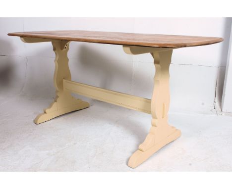 A 20th century vintage Ercol refectory dining table having wax polished top raised over shabby chic painted base with lyre su