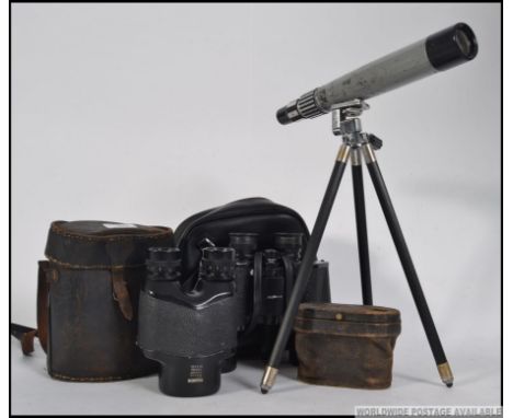 A Magnon No 2338 field monocular together with a pair of Tasco binoculars and a small telescope with tripod stand. Measures: 