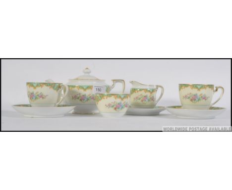 A Noritake Japanese vintage floral posy pattern bone china ware . Select pieces including : teapot , creamer , 2 cups and sau