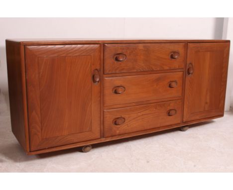 A retro 1960's oak Ercol golden dawn ' Windsor Pattern ' sideboard dresser having a central bank of three drawers flanked by 