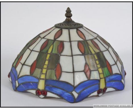 A 20th century Tiffany style leaded marbled and stained glass ceiling light shade along with another similar lamp shade.  Mea