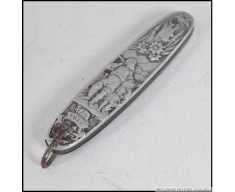 A silver white metal continental  fruit / pen knife, heavily decorated with classical scenes. Measures: 7cm H.