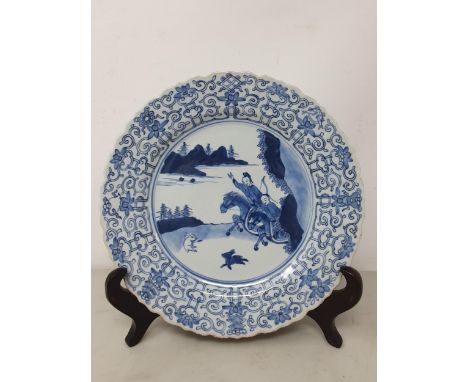 A KANGXI Period Chinese blue and white Plate, with shaped rim with floral and scrolled border and two small fish, the centre 