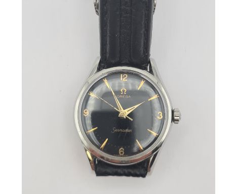 A gentleman's Omega Seamaster Automatic Wristwatch the black dial with arabic numerals at quarters the remainder baton marker