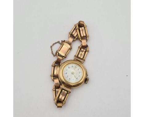 A lady's Wristwatch the white enamel dial with arabic numerals in case marked 14K, case width approx 27mm, on fancy link brac