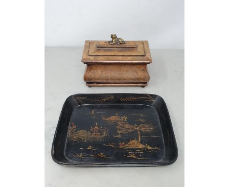 A 19th Century walnut sarcophagus-shaped Tea Caddy, with stepped lid and brass handle/finial in the form of a King Charles Sp