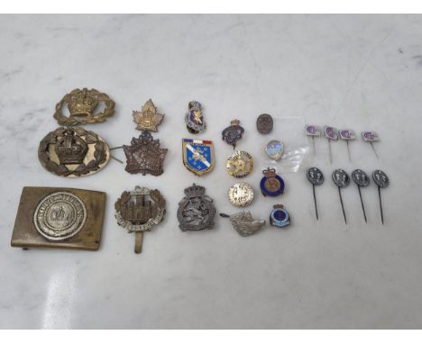 A collection of Military Badges including a WWI German Belt Buckle, Essex Regiment Cap Badge, Belgian Army in United Kingdom 