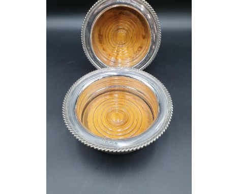 A pair of George V circular Coasters with gadroon rims, turned wooden bases, engraved inscription, Sheffield 1932/3, William 