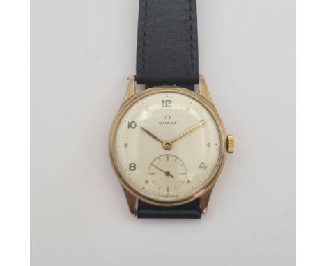 A gentleman's manual wind Omega Wristwatch the champagne dial with alternating arabic numerals and dot markers and subsidiary
