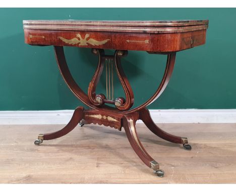 An early 19th Century mahogany Card Table, possibly American, with fold-over top, the frieze with brass inlay of a double eag