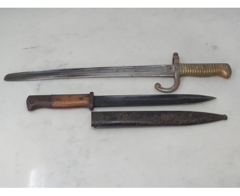 A German Mauser Bayonet in scabbard and a French Bayonet with altered blade and brass grip Scabbard numbered 04166K, blade ma