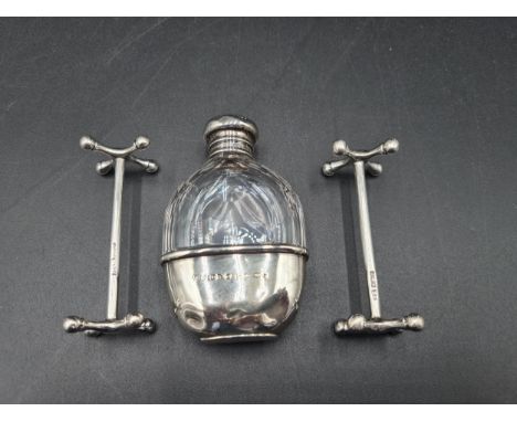 A Victorian silver lidded small Spirit Flask with silver cup base, Chester 1894, and a pair of silver Knife Rests, Sheffield 