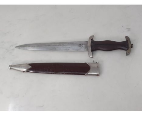 A WWII German SA Dagger in brown scabbard with wooden grip lacking emblem, blade engraved 'RZM M7/85'