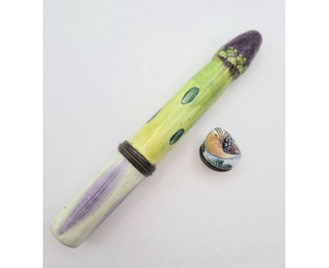 An enamel Needle Case formed as an asparagus spear, approx 4 1/2in long and a small enamel Fob formed as partridge on a nest 