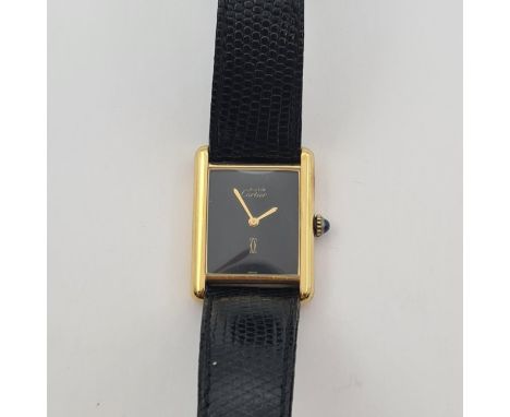 A lady's Must de Cartier manual wind Tank Wristwatch the rectangular black dial with gold hands, sapphire cabochon to crown i
