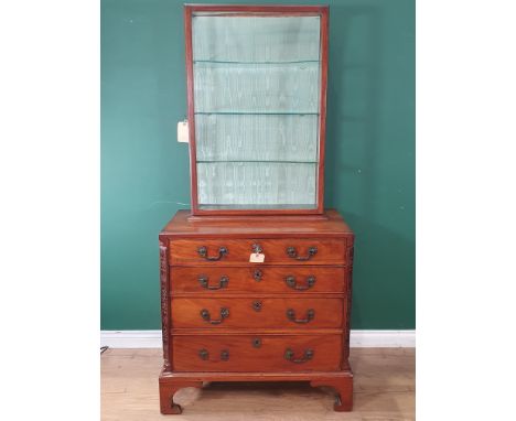 A George III Chest of drawers in the Chippendale manner with glazed Cabinet top, the Chest fitted four long graduated drawers